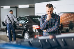 Used Cars: Private or Trade? The Pros and Cons of Weighing the Options 2 editors images 1674458899608 young man choosing car car showroom