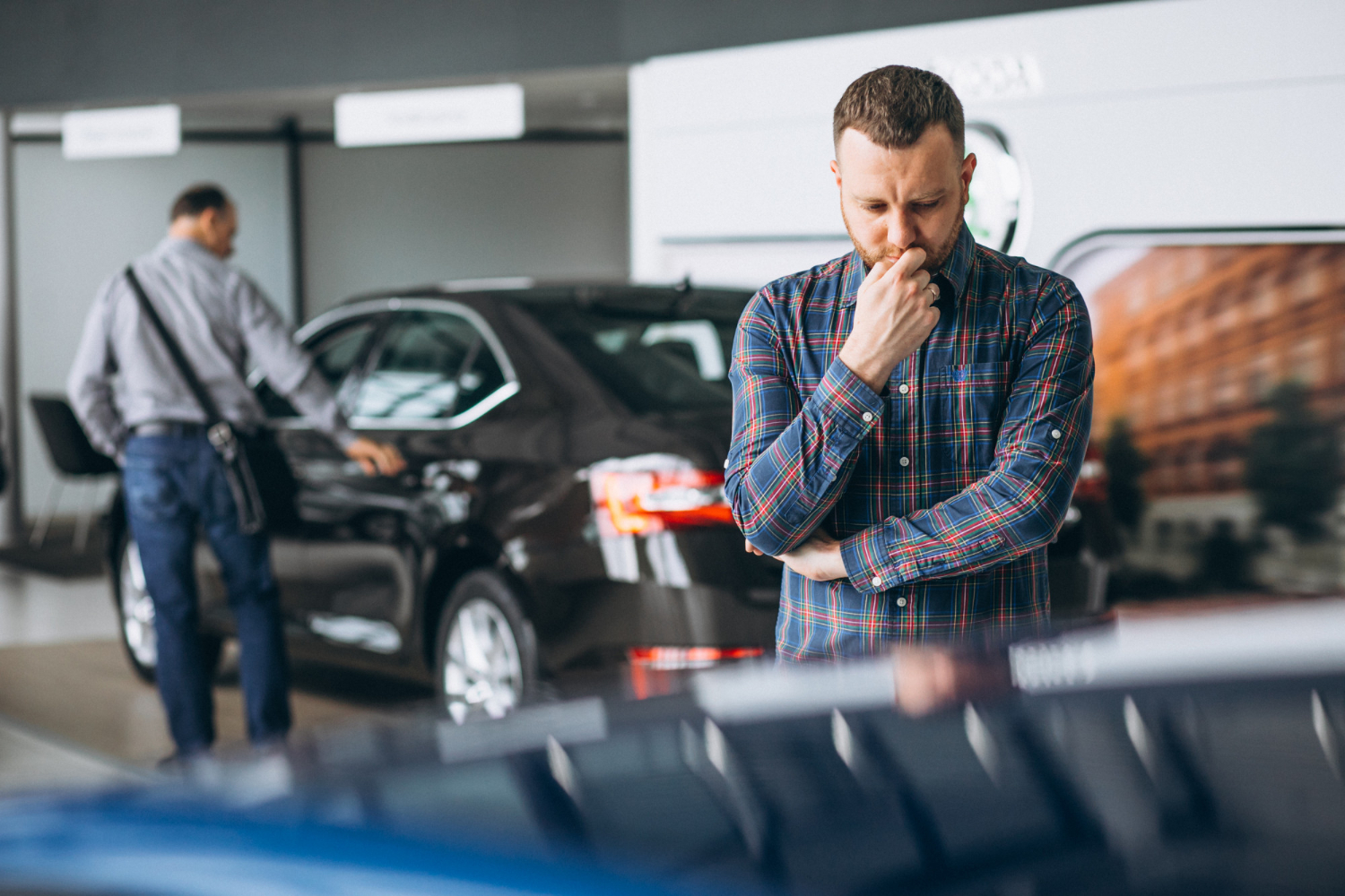 Used Cars: Private or Trade? The Pros and Cons of Weighing the Options 1 editors images 1674458899608 young man choosing car car showroom